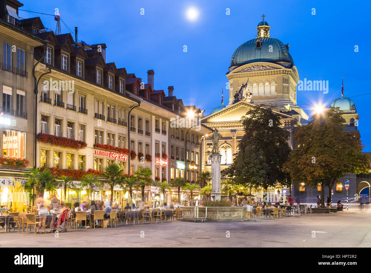 BERN, SIWTZERLAND - SEPTEMBER 12, 2016: People enjoy dinner in restaurants right in front of the Federal Palace in Bern, where seats the Swiss governm Stock Photo