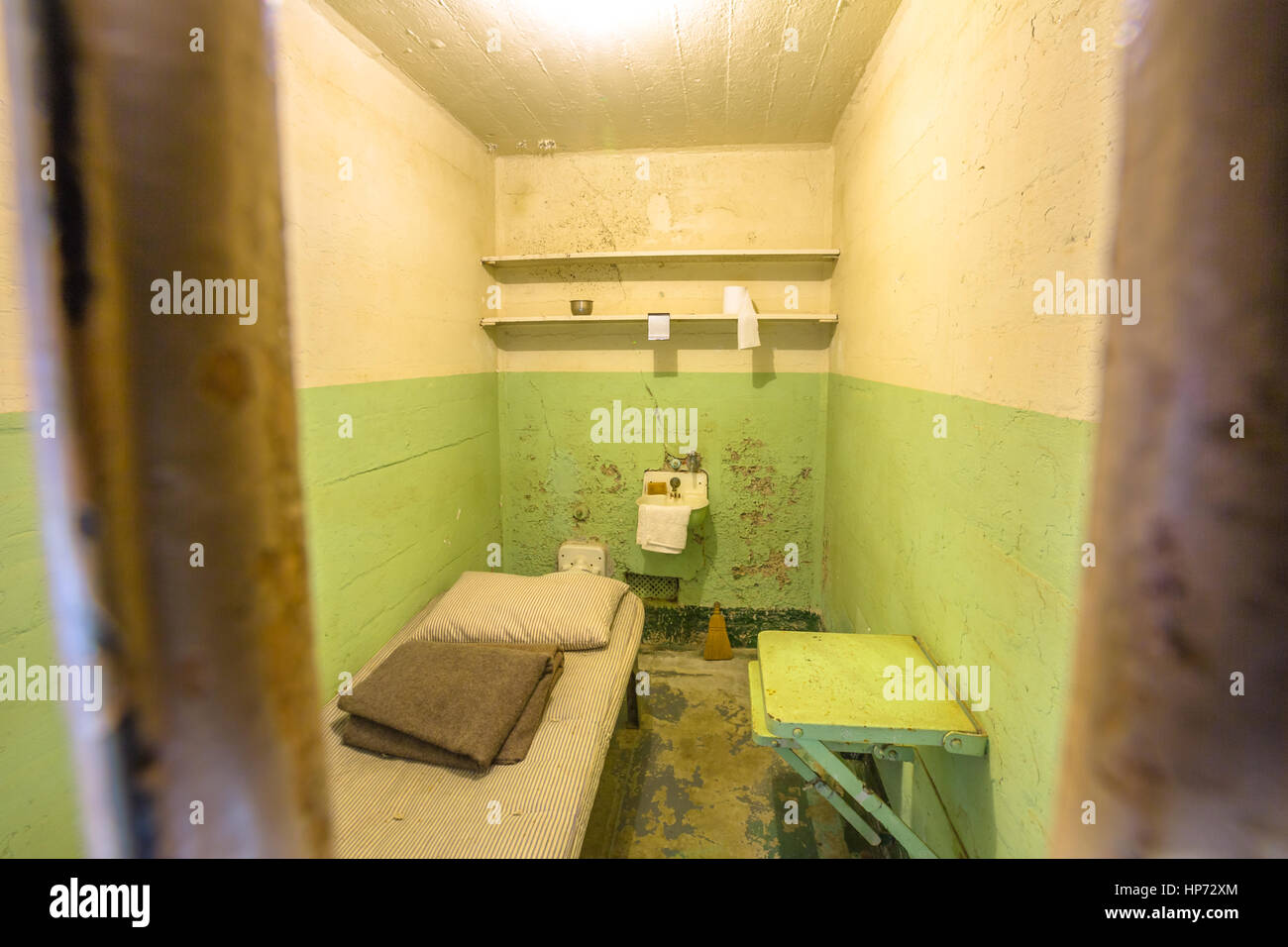 San Francisco, California, United States - August 14, 2016: detail inside Alcatraz ordinary single cell on ground level. All cells have a private toil Stock Photo