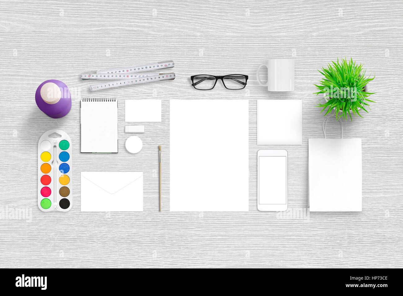 Brand identity portfolio presentation. Top view scene with isolated, blank stationery. Smart phone for app design showcase. Stock Photo