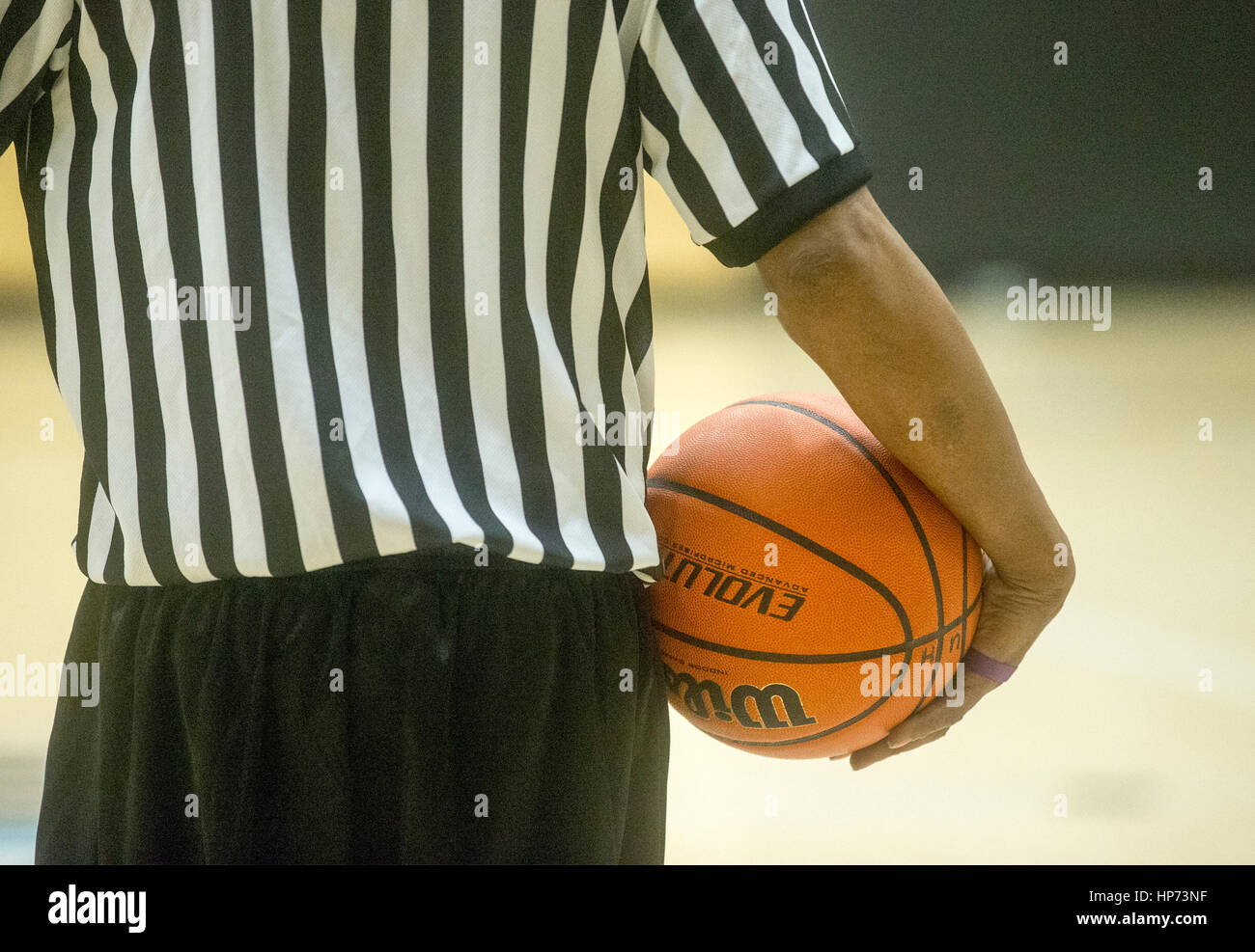 A basketball referee holding a ball during a timeout Stock Photo