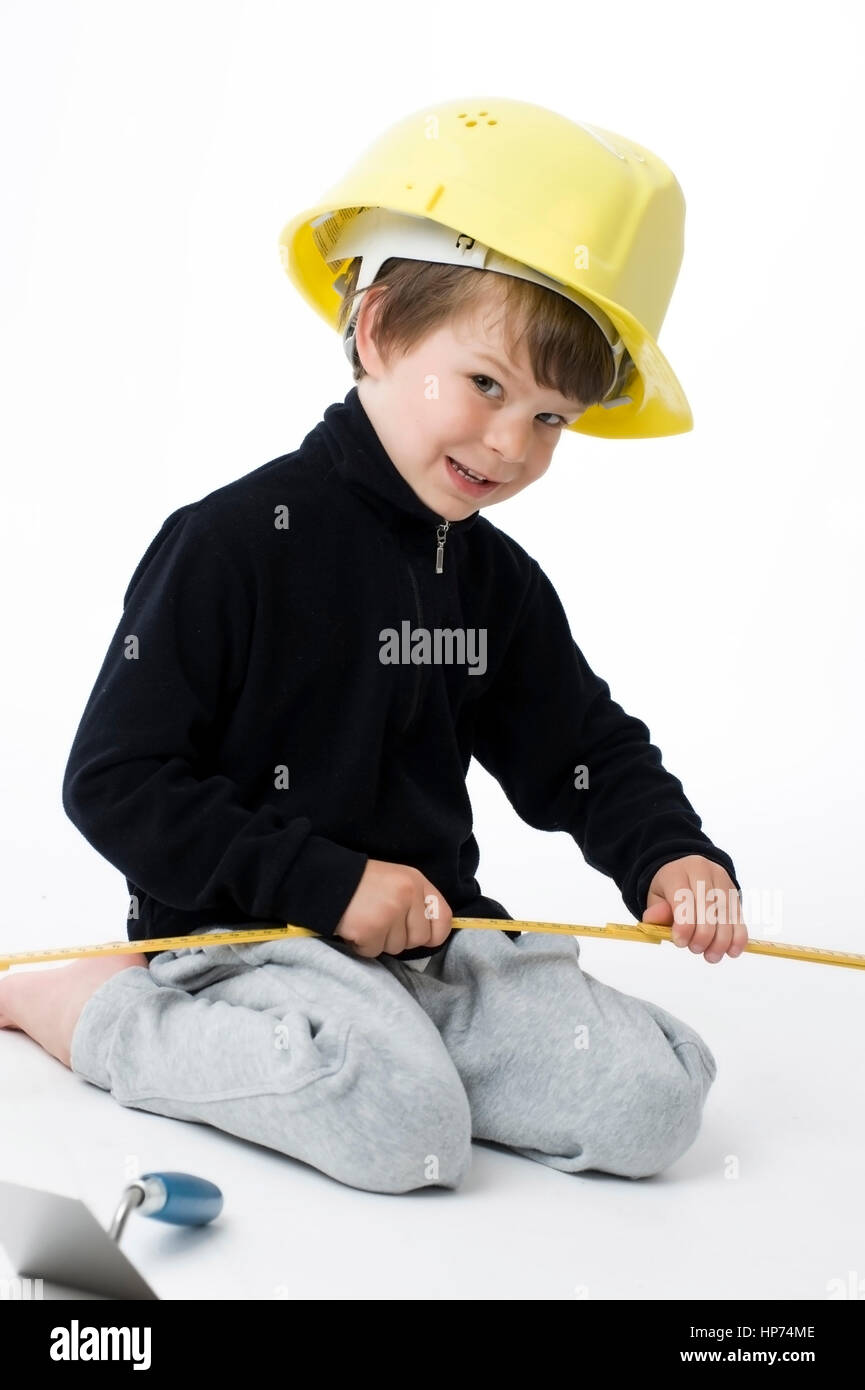 Model released, Junge, 4, mit Bauarbeiterhelm und Zollstock - boy with building-site helmet and  Zollstock folding ruler Stock Photo
