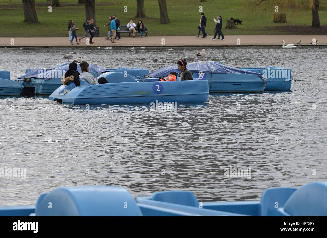 People on a pedalo on the Serpentine lake in Hyde Park, central London