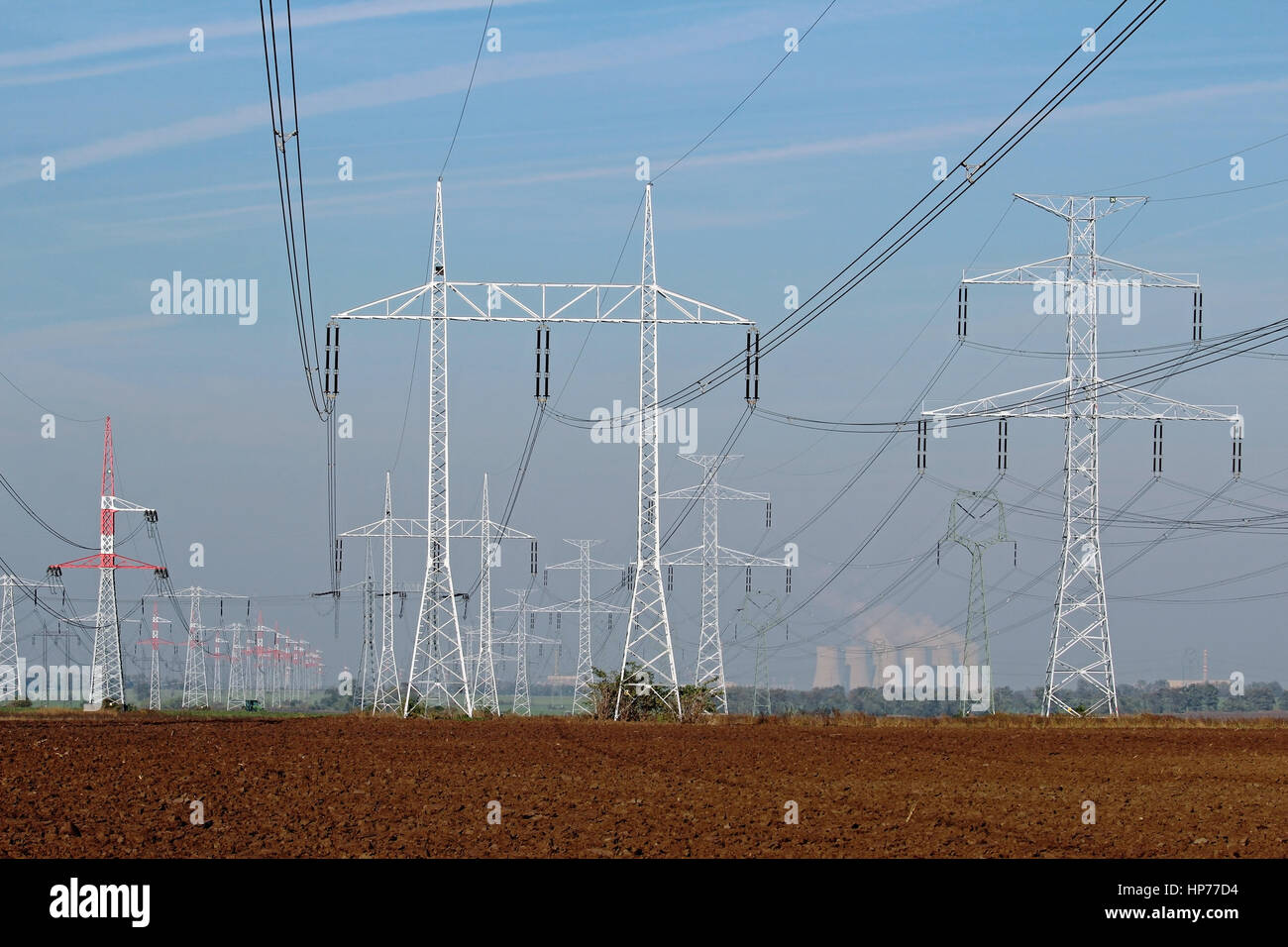 line of electricity pylons and nuclear power plant Stock Photo