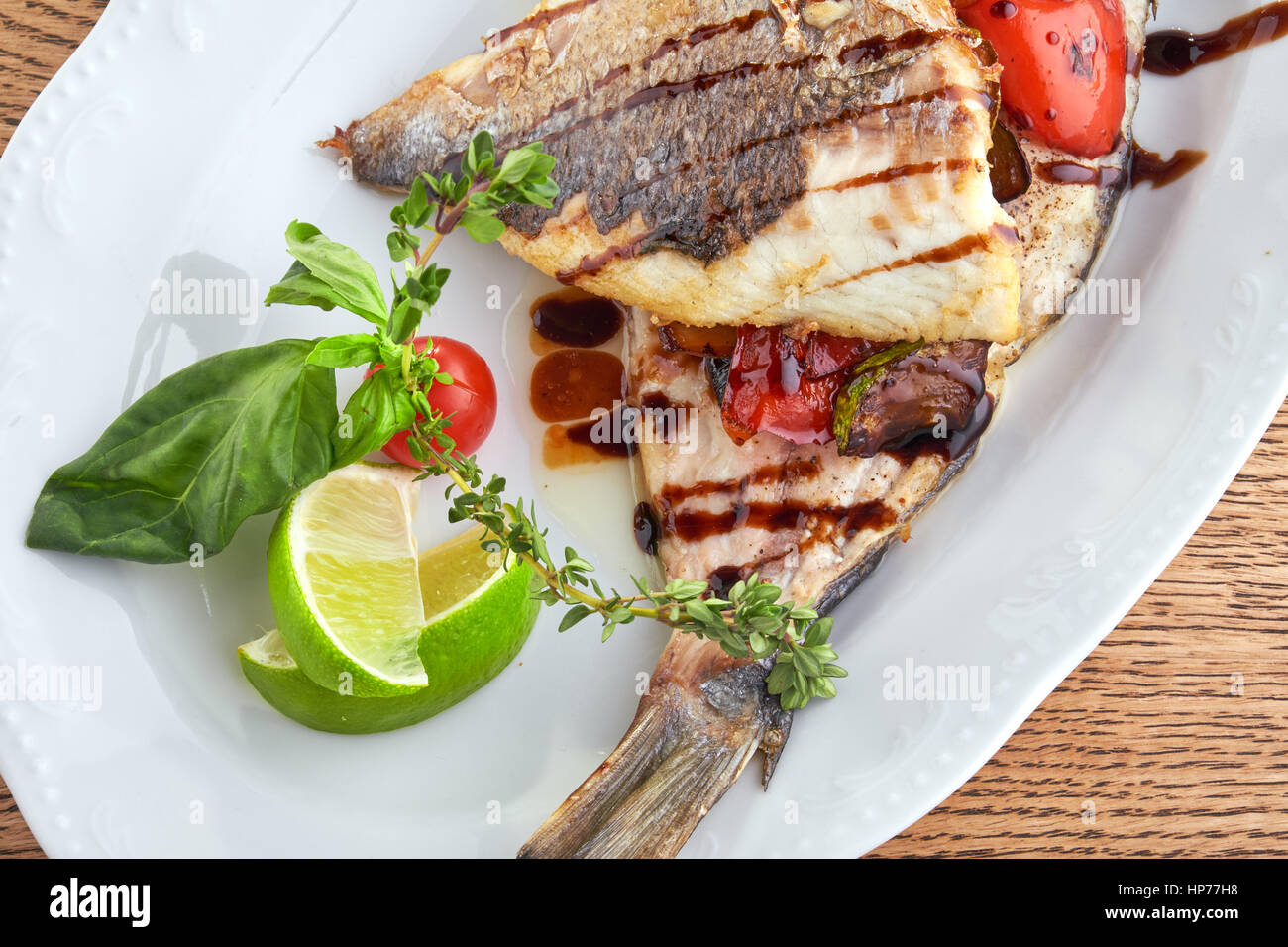 Fried fish on a white plate Stock Photo