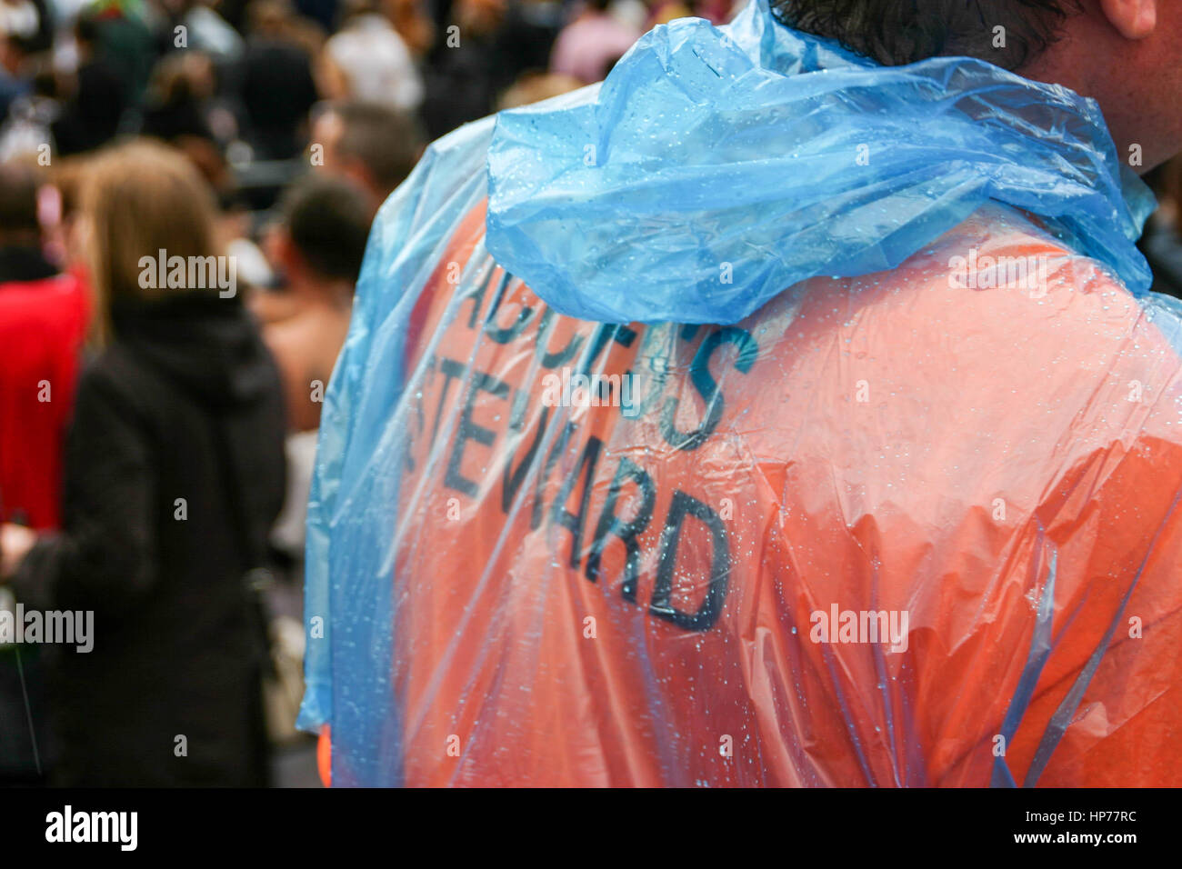 Access steward working at an organised event in the rain Stock Photo