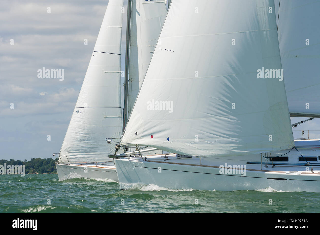 Two beautiful white yachts sailing close to each other on a bright sunny day Stock Photo
