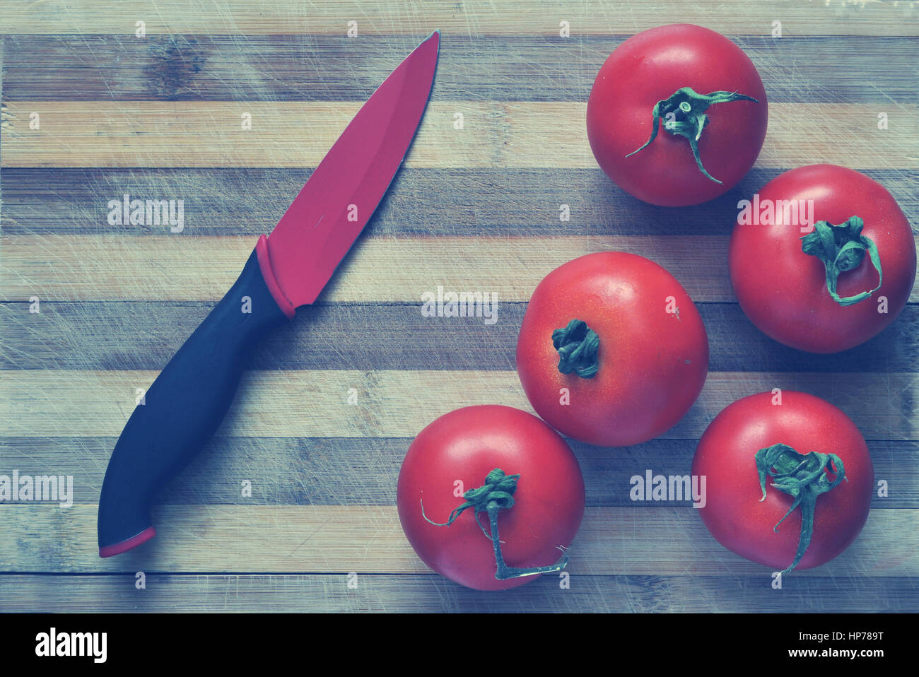 Red tomatoes on a cutting board. Toned Stock Photo - Alamy