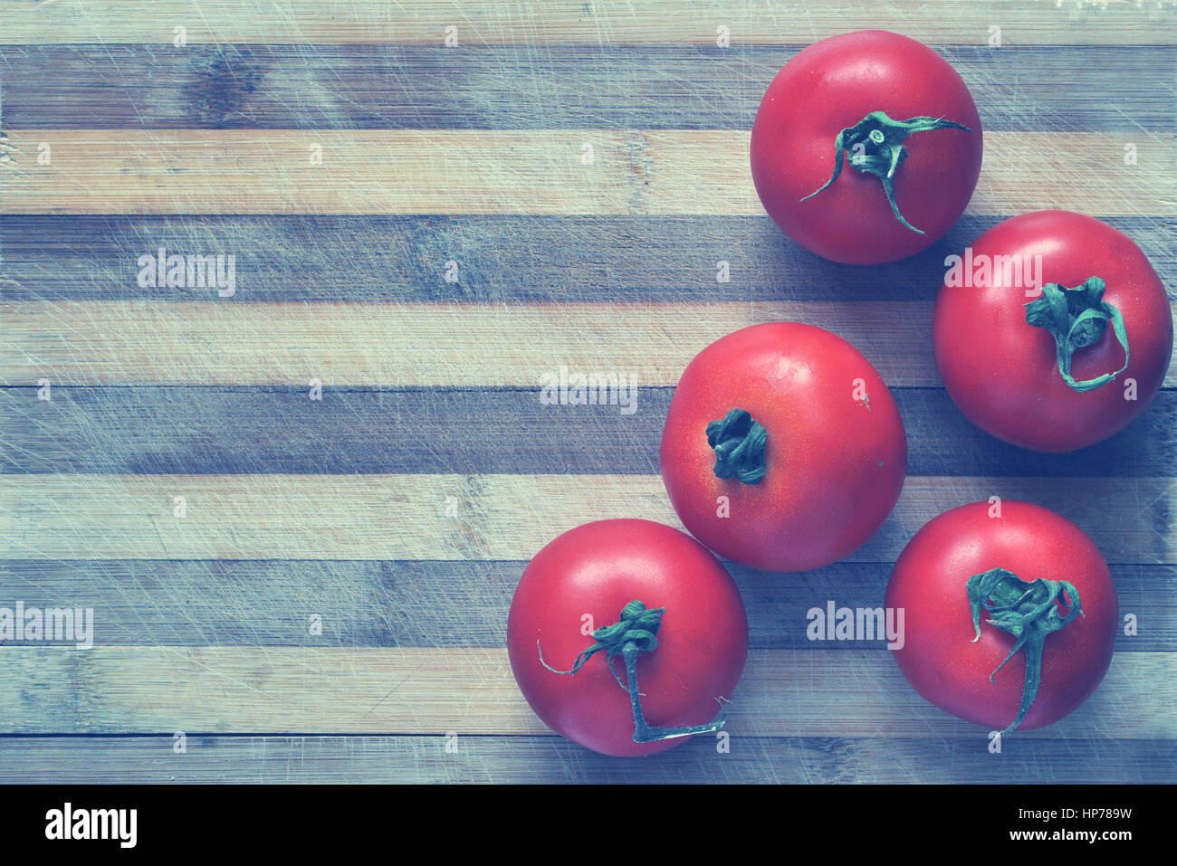 Red tomatoes on a cutting board. Toned Stock Photo - Alamy