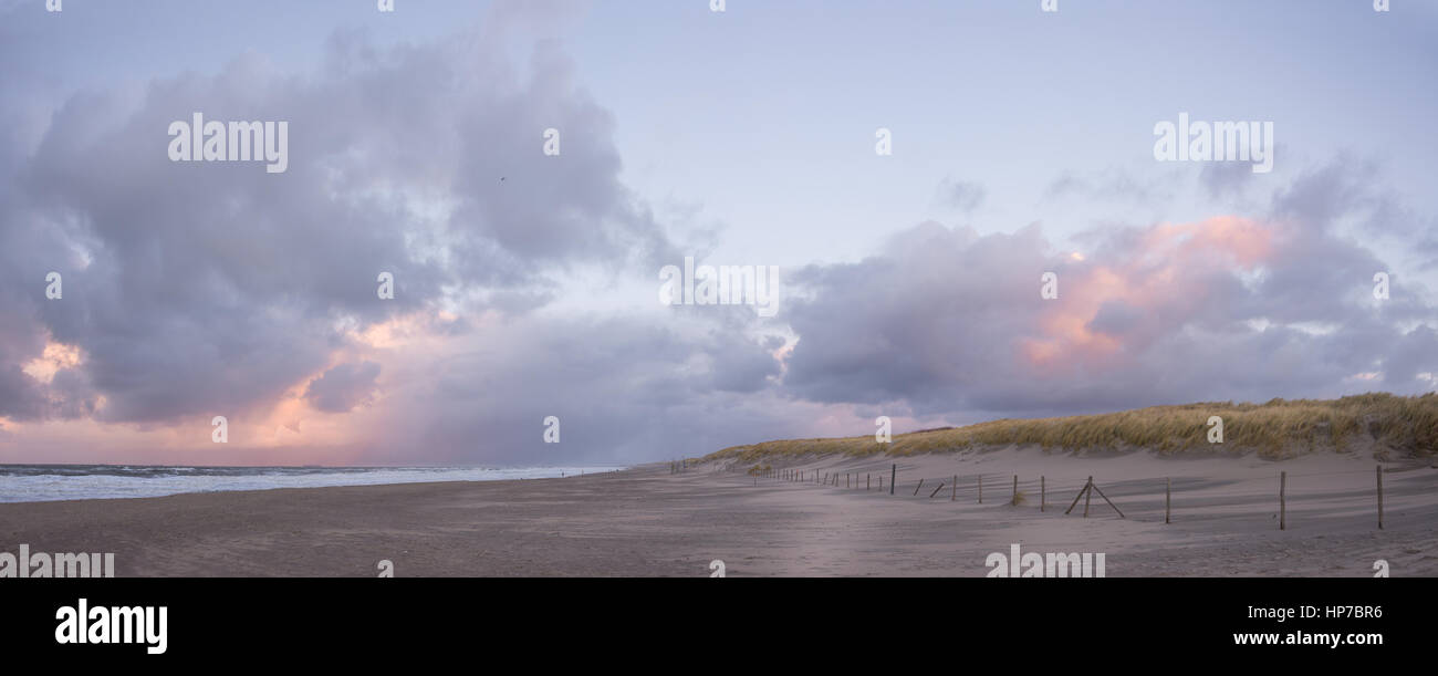 Panorama image of dunes with grass, a sand beach and the North Sea at ...