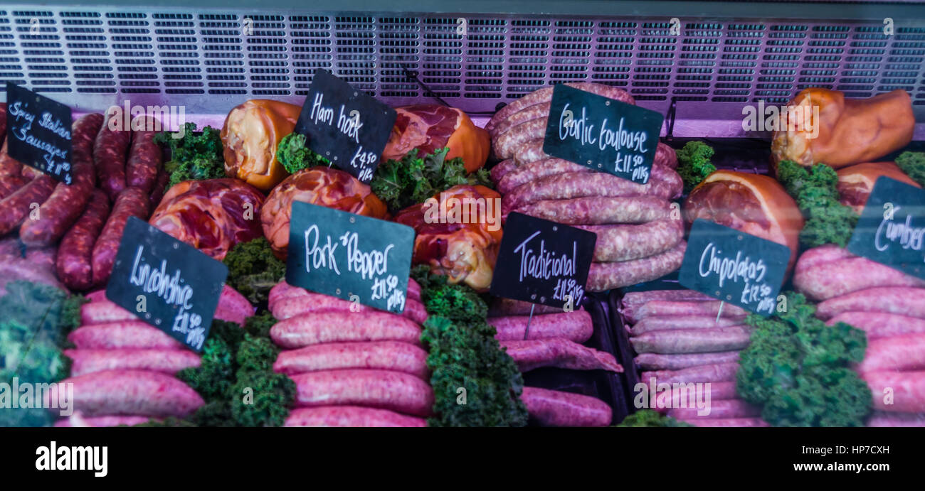 a large selection of meats, cold cuts and sausages with prices