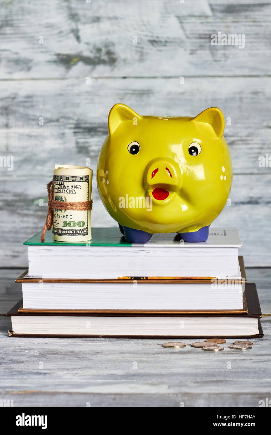 Books and money box. Savings for education Stock Photo Alamy