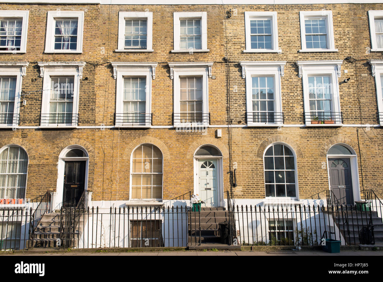 Facade of Victorian residential town houses made in yellow brick in a