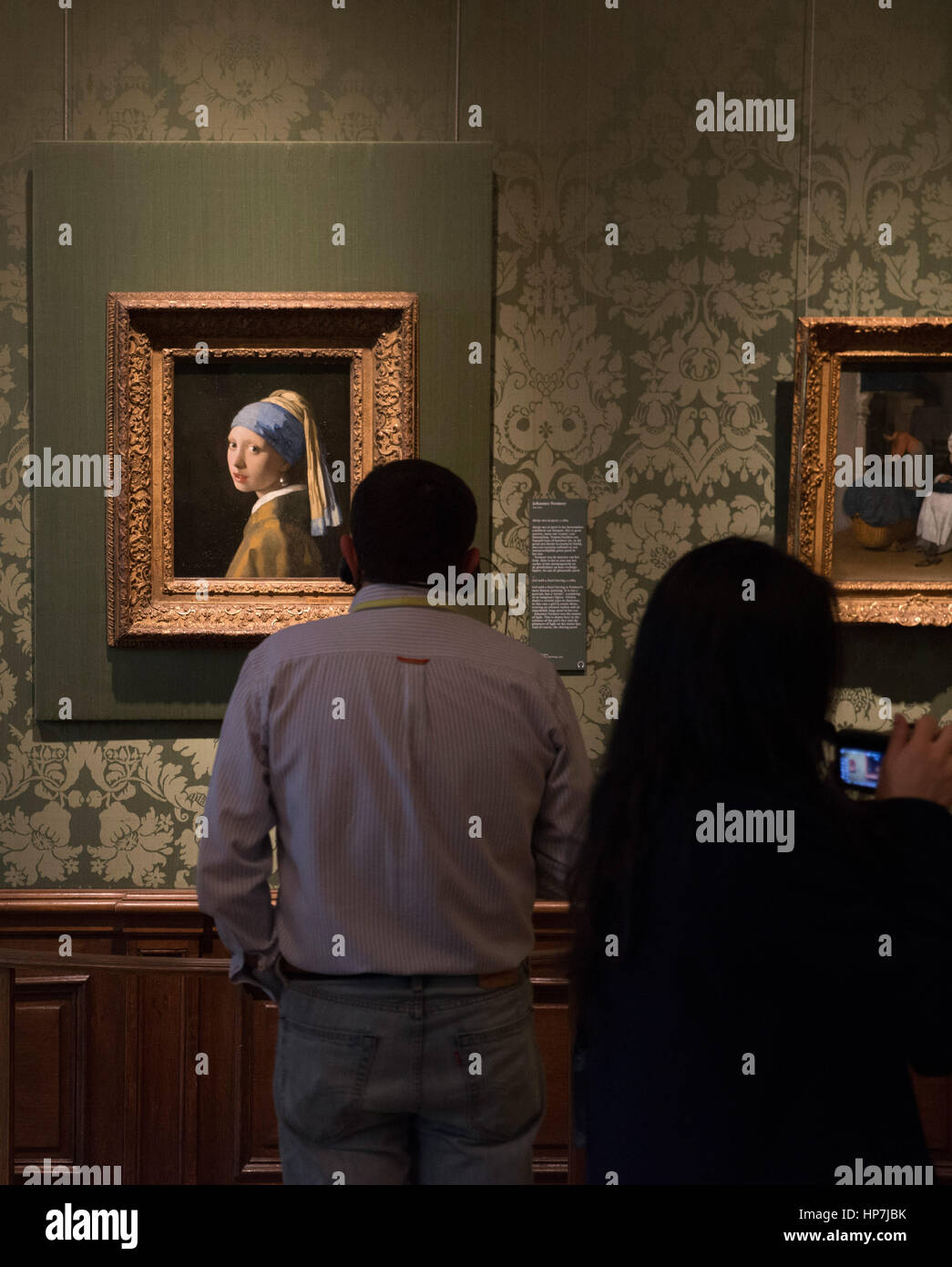 Visitors admiring and photographing Johannes Vermeer, Girl with a Pearl Earring (Meisje met de parel) 1665  - Mauritshuis Museum The Hague Stock Photo