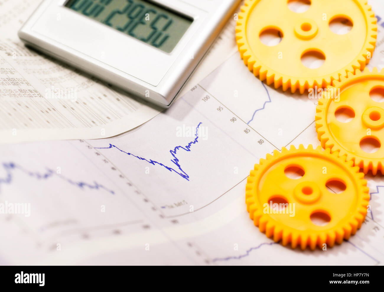 Graphics with curves, three gear wheels and a calculator Stock Photo Alamy