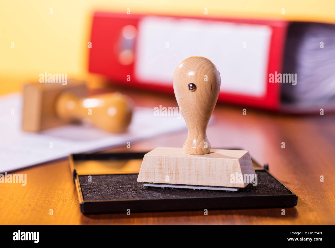 Desk with stamp, file folder and a document. Stock Photo