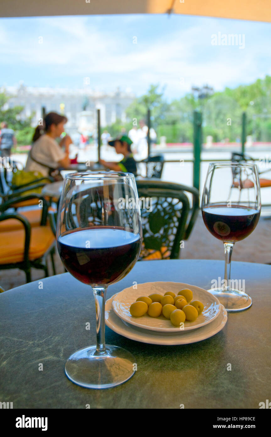 Two glasses of red wine and olives in a terrace. Oriente Square, Madrid,  Spain Stock Photo - Alamy