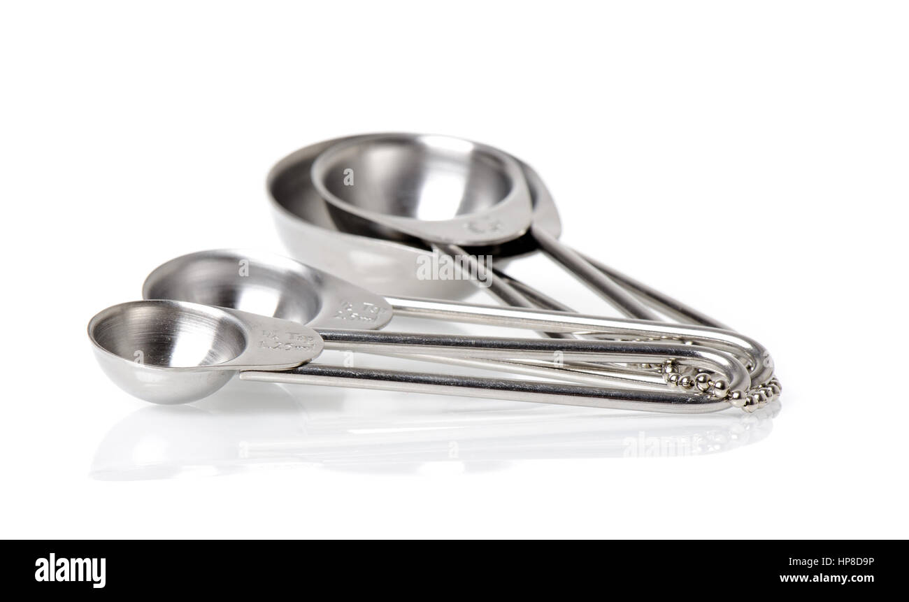 set of stainless steel measuring spoons in varying sizes Stock Photo