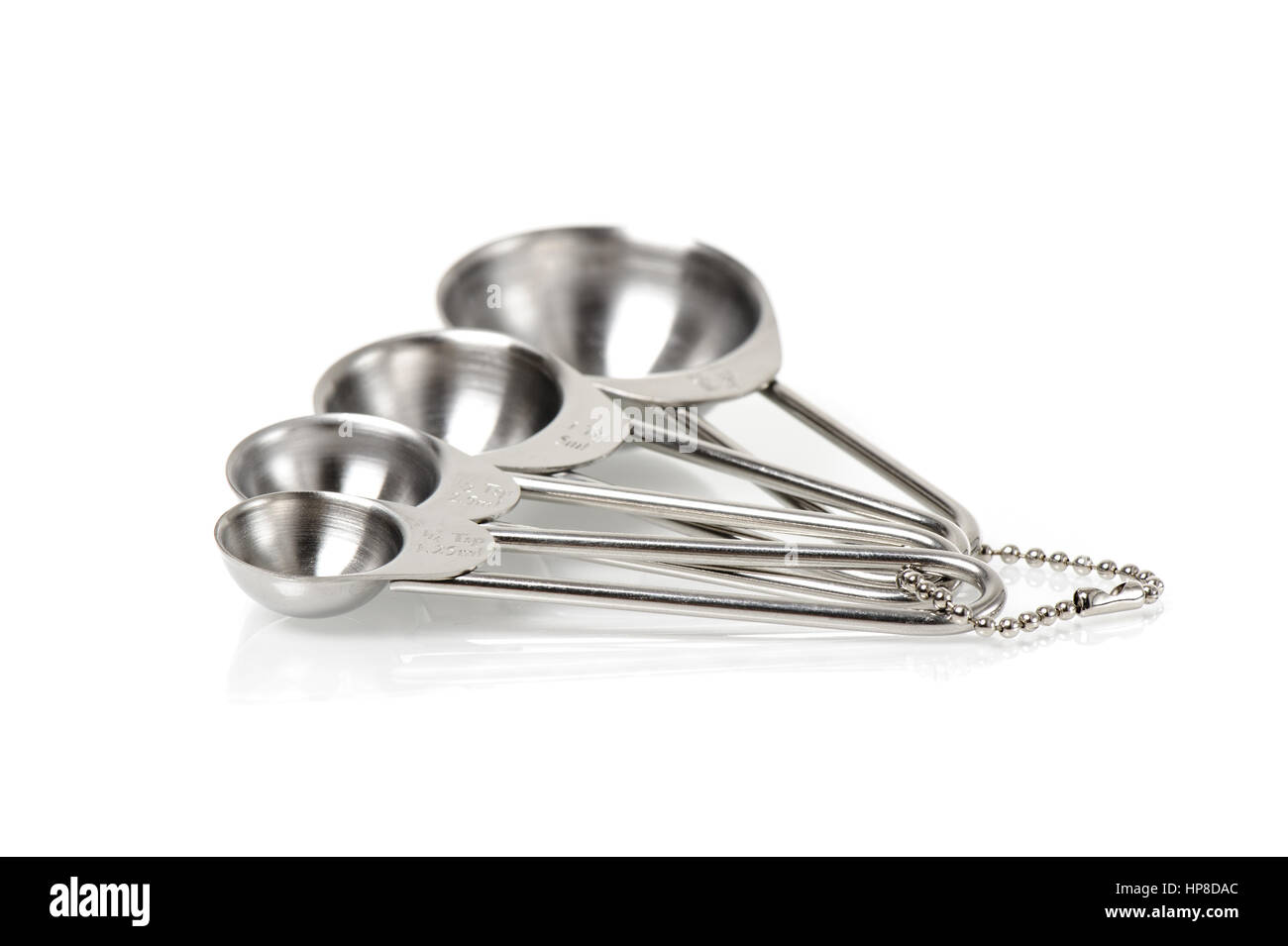 set of stainless steel measuring spoons in varying sizes Stock Photo
