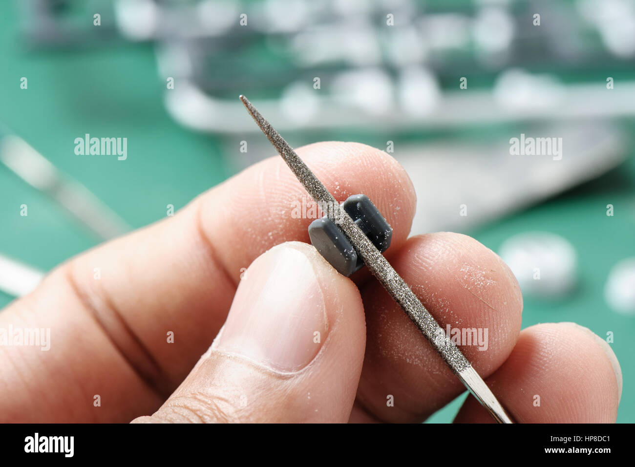 closeup a man's hand sanding a plastic model with rasp Stock Photo Alamy