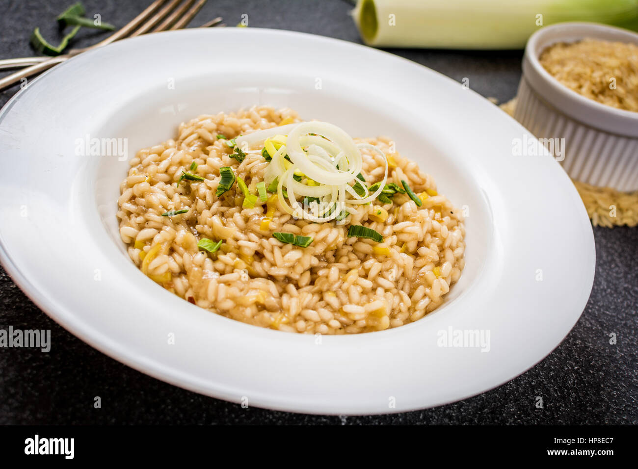 Italian rice arborio risotto with leek on white table Stock Photo Alamy