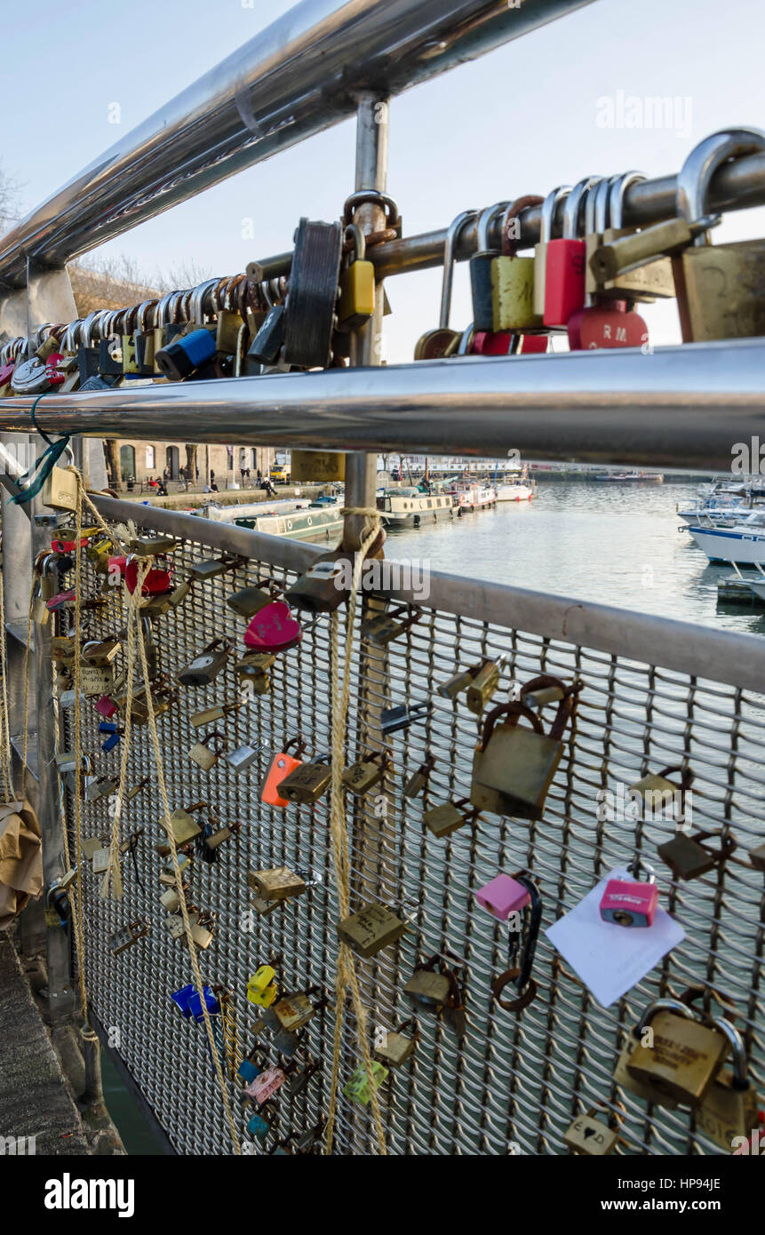 Love locks left on Pero's Bridge which spans Bristol Harbour. Romantic tourists leave padlocks on the bridge as a romantic gesture. Stock Photo