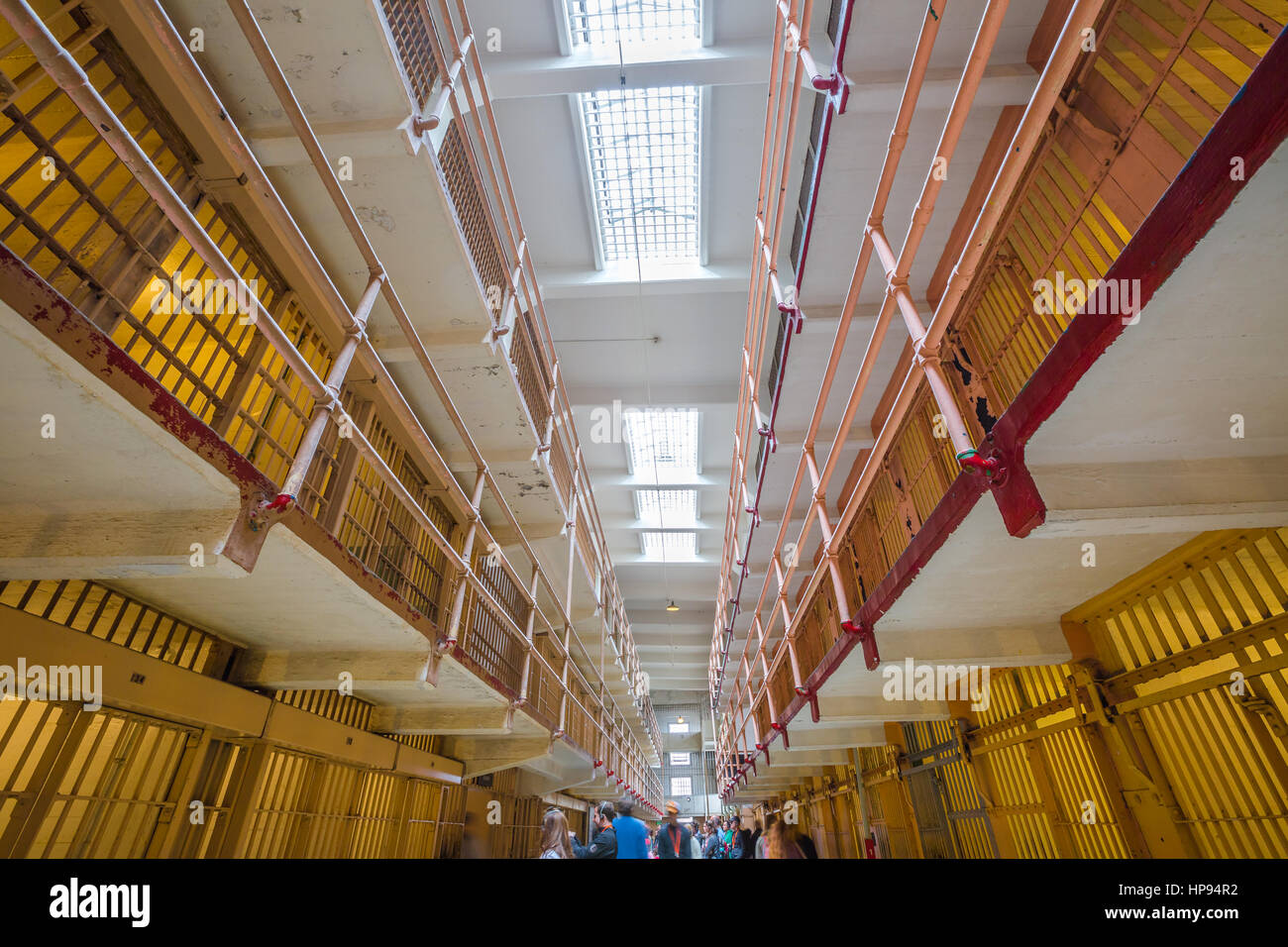 San Francisco, California, United States - August 14, 2016: tourists visiting Alcatraz prison in main corridor upper cells on both sides on three leve Stock Photo