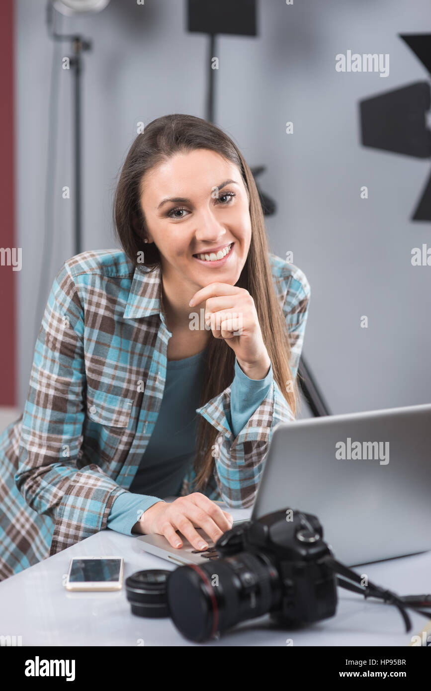 Female photographer working in her professional photo studio with a