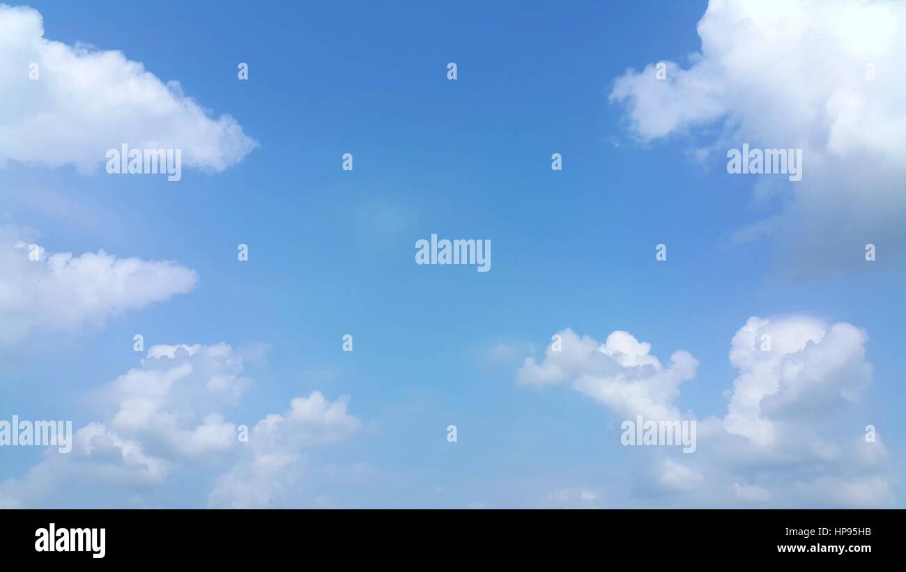 Clear blue sky with soft white clouds Stock Photo - Alamy