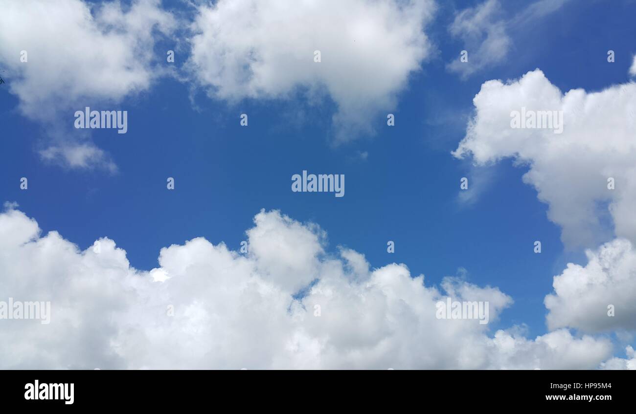 Clear blue sky with soft white clouds Stock Photo - Alamy