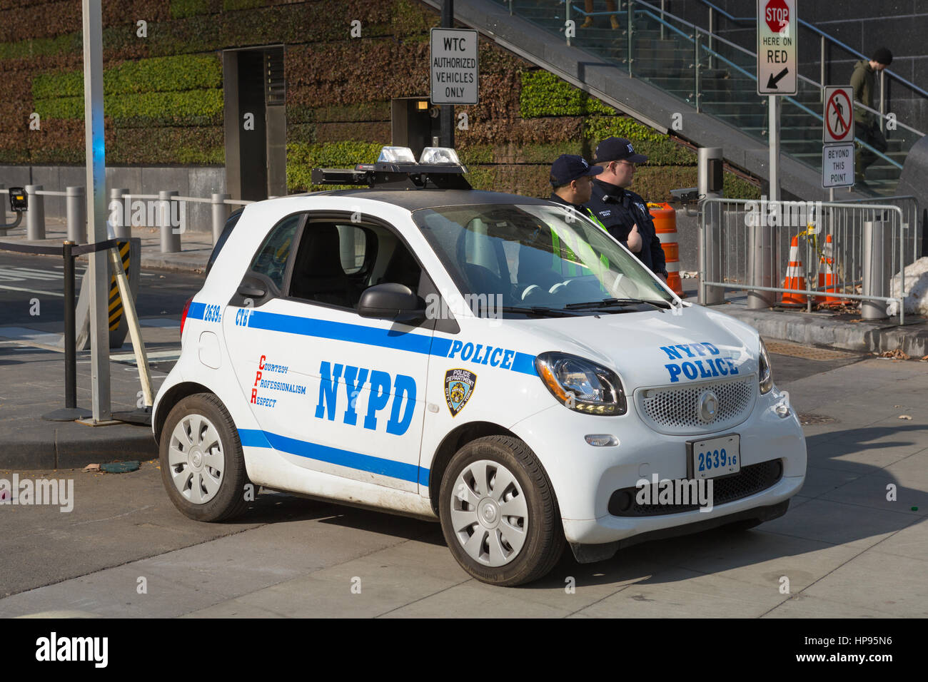 NYPD Counterterrorism Bureau officers, using a new Smart Fortwo smart car, provide security at the World Trade Center site in New York City. Stock Photo