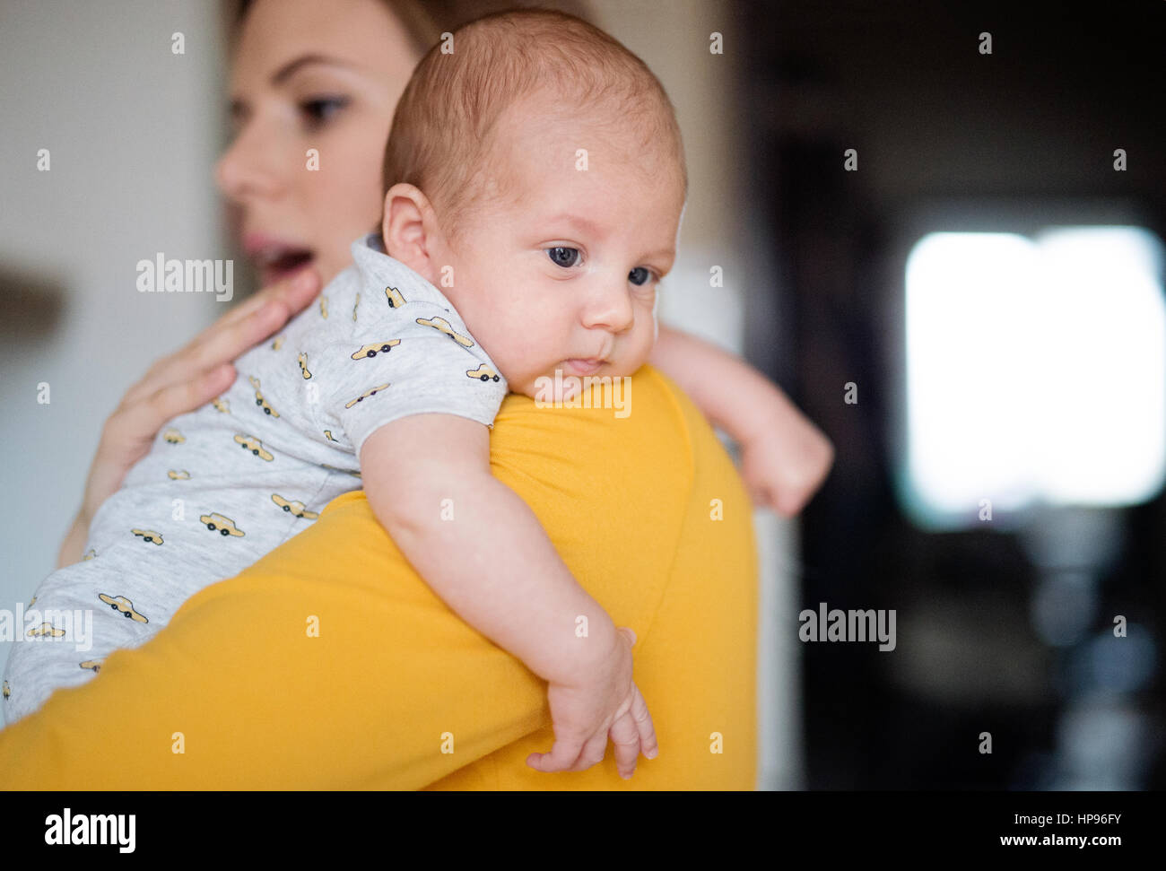 Beautiful young mother holding baby son in her arms Stock Photo - Alamy