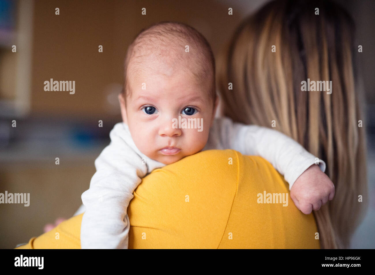 Beautiful young mother holding baby son in her arms Stock Photo - Alamy