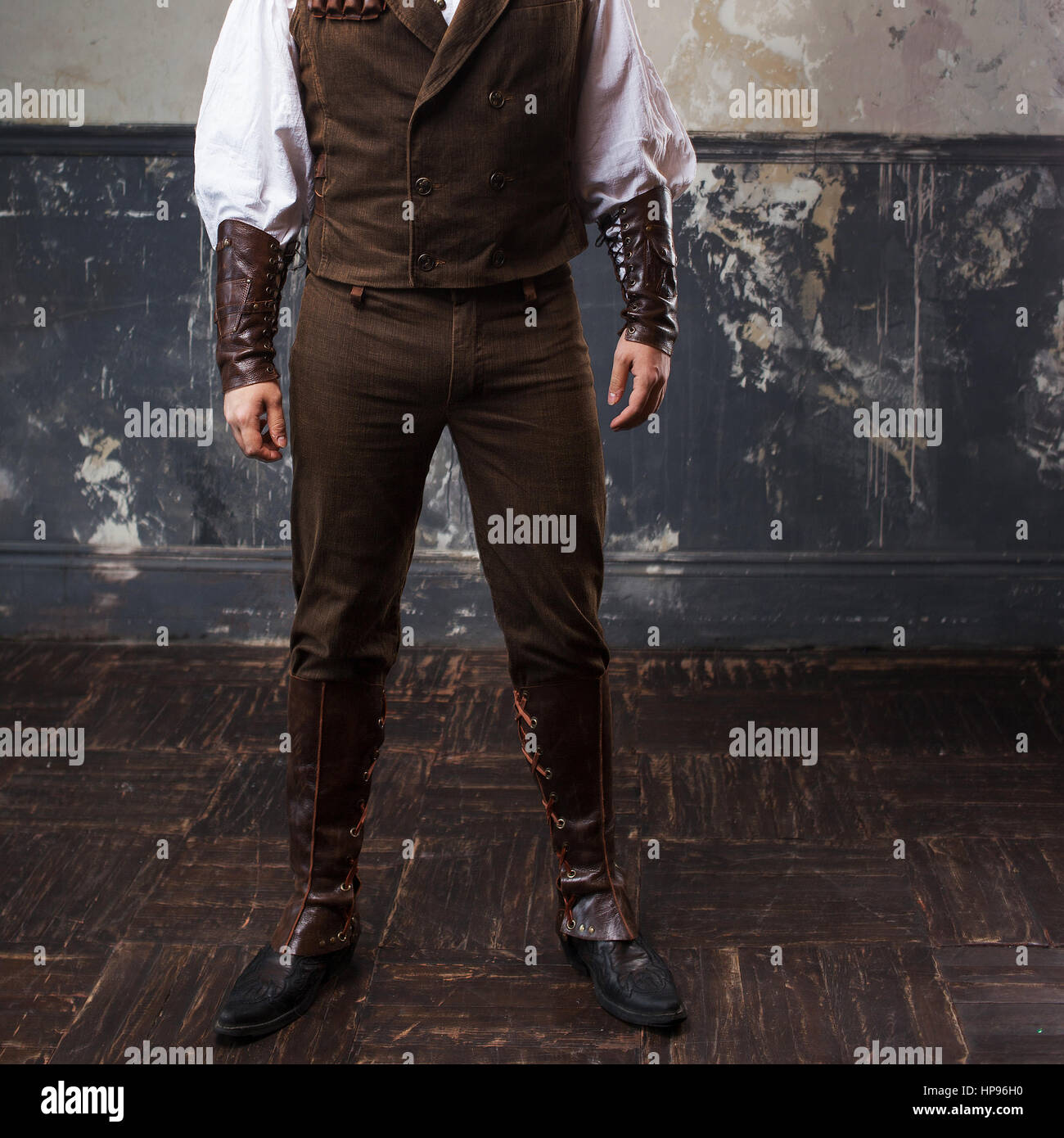 Handsome male Steam punk. Retro man over grunge background. Suit, pants