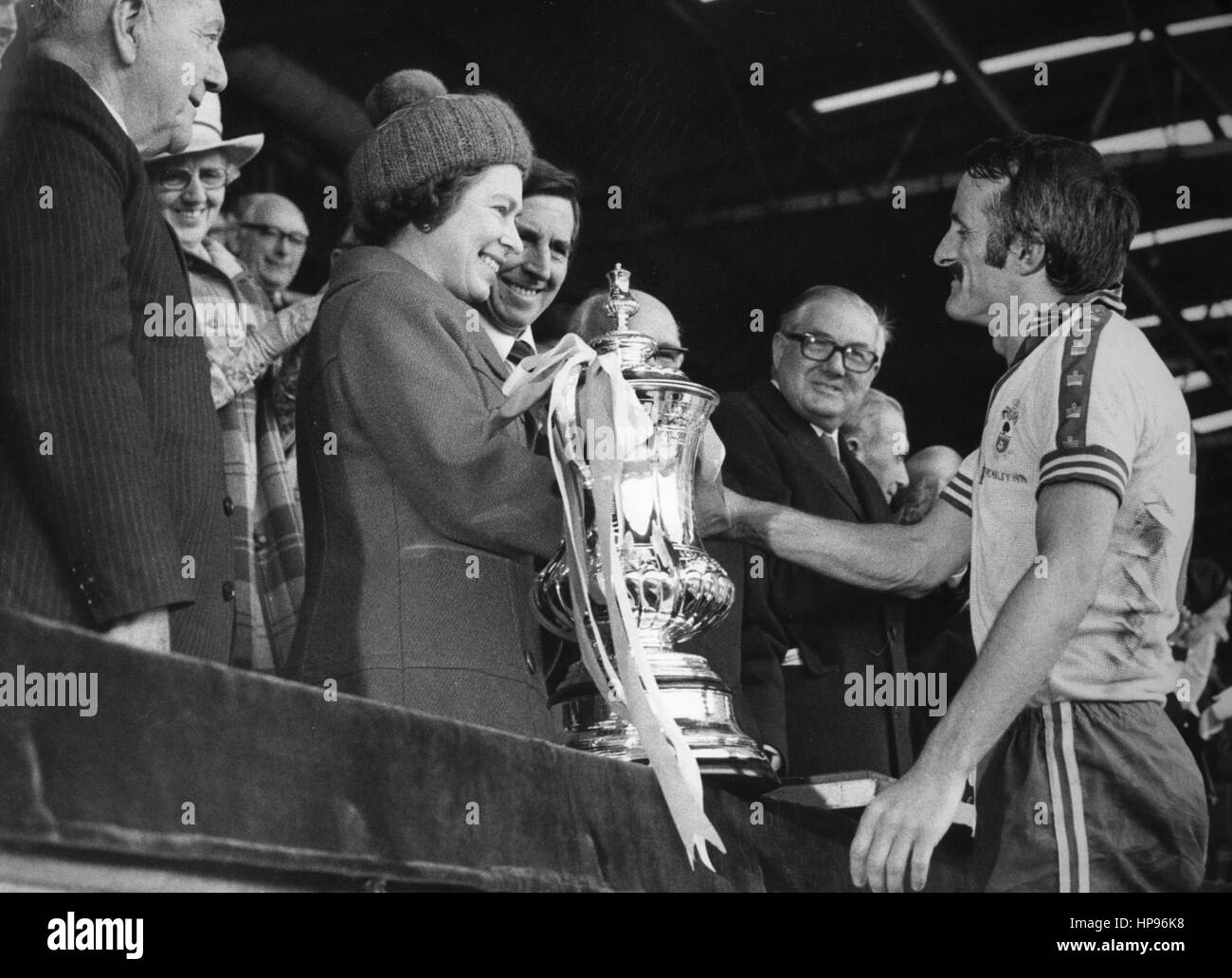 File photo dated 01-05-1976 of Queen Elizabeth II presents Southampton captain Peter Rodrigues with the FA Cup at Wembley. They beat Manchester United 1-0. Prime Minister James Callaghan is in the background. Stock Photo