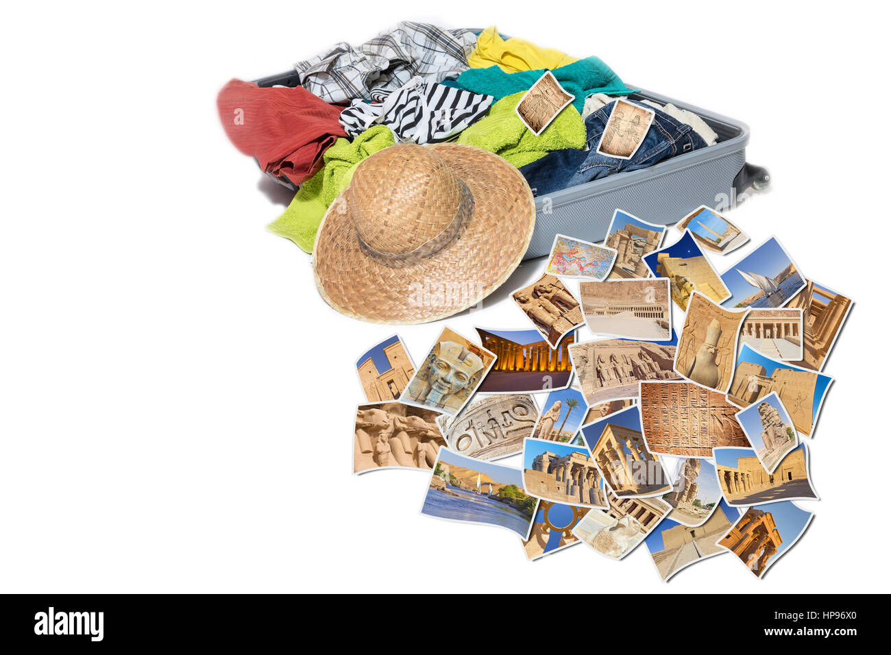 Studio shot of a suitcase with scattered clothing and straw hat. Photos of Egypt landmarks are lying in front of the suitcase. Everything is on a whit Stock Photo