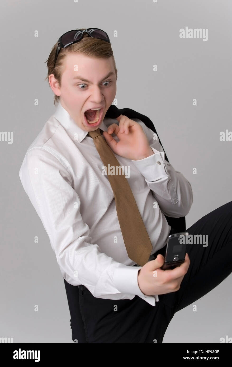 Model released , Junger Gesch?ftsmann mit Handy - young businessman with mobile phone Stock Photo
