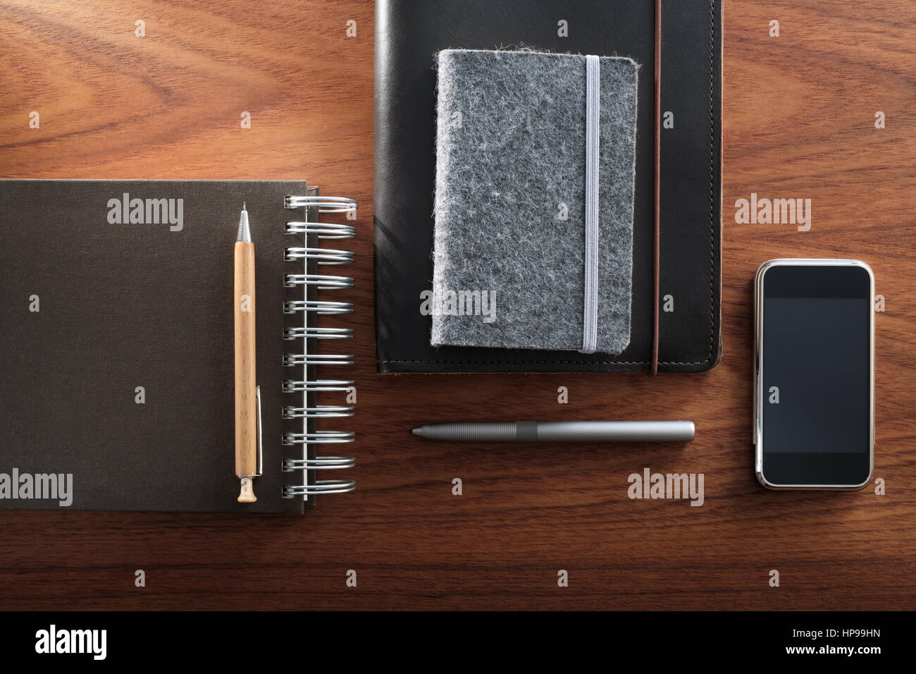 Notepads, pencil, smartphone and digital pen. Analog vs digital. Stock Photo