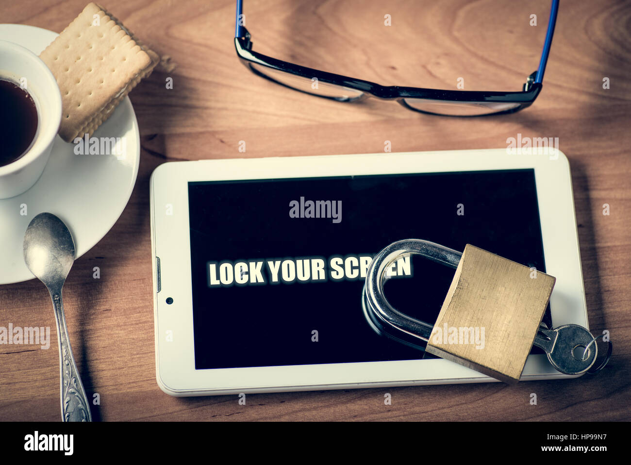 Tablet and padlock on the screen warning to lock you screen Stock Photo