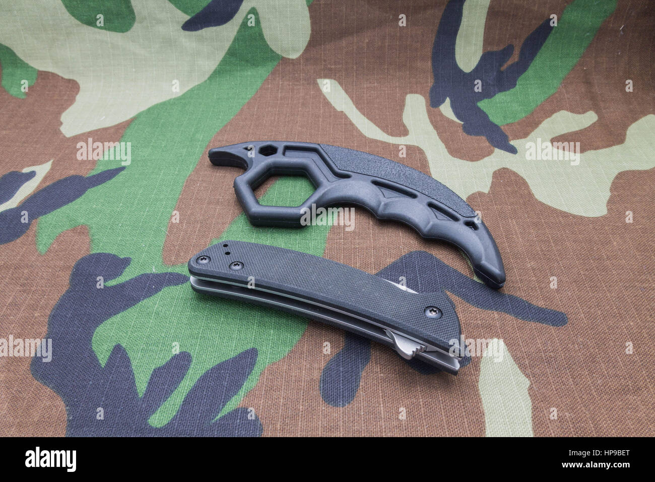 Folded knife on the military uniform. Brass knuckles Stock Photo Alamy