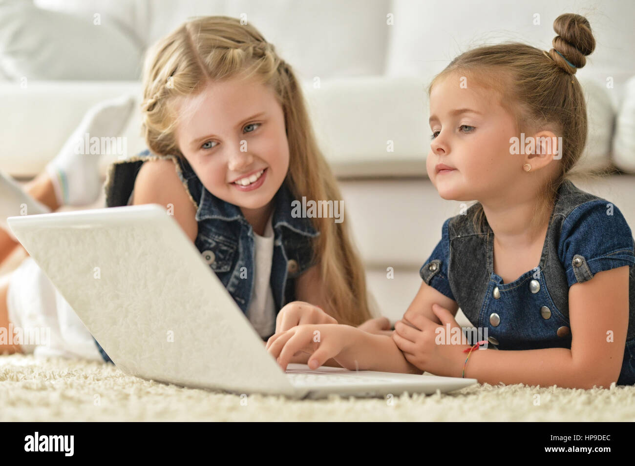 sisters using laptop Stock Photo - Alamy
