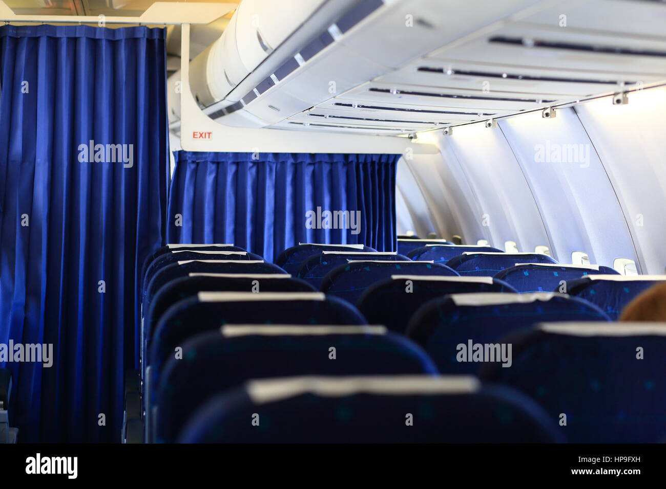 Blue seats and white panel inside airplane Stock Photo Alamy