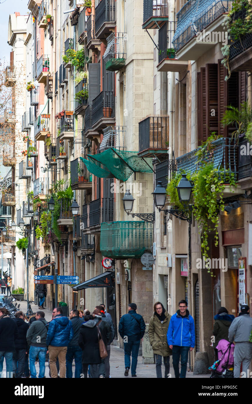 Narrow streets with residential apartments above in old town (Latin quarter) of Barcelona, Catalonia, Spain. Stock Photo