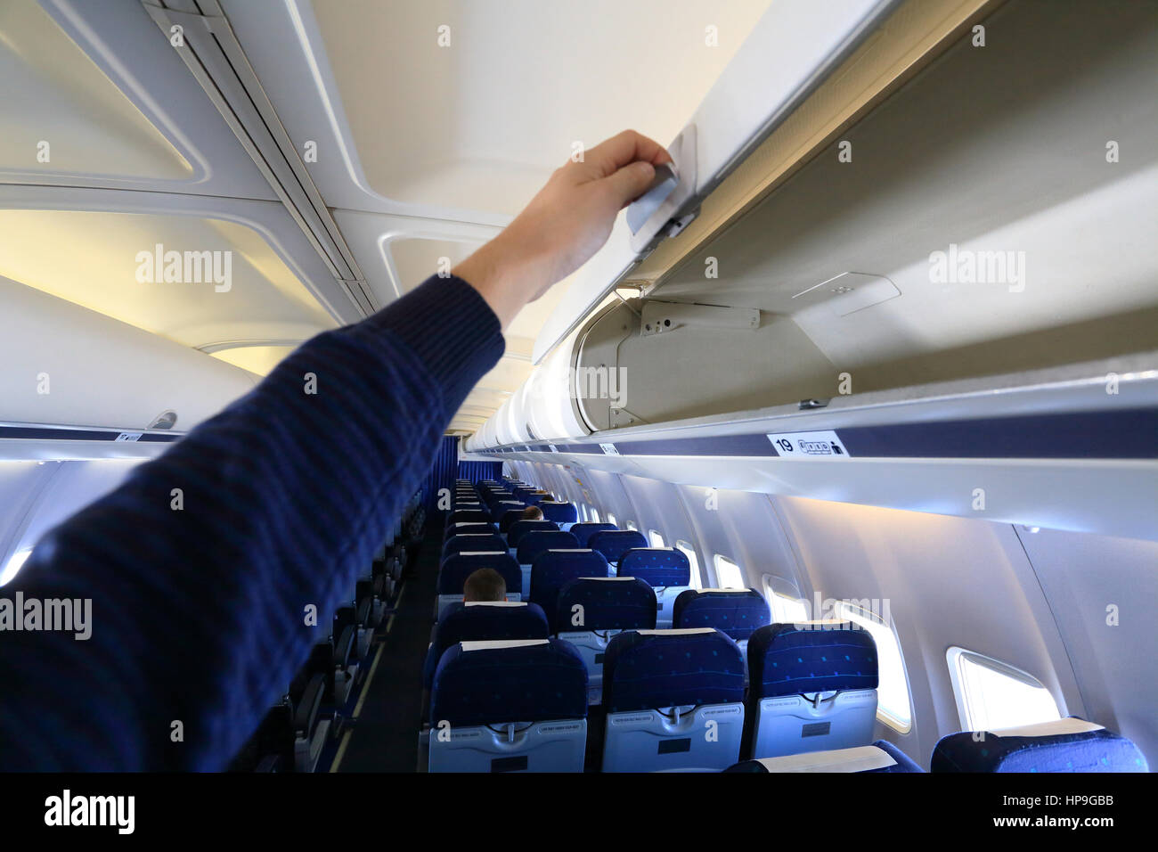 Open white empty  luggage panel in airplane Stock Photo