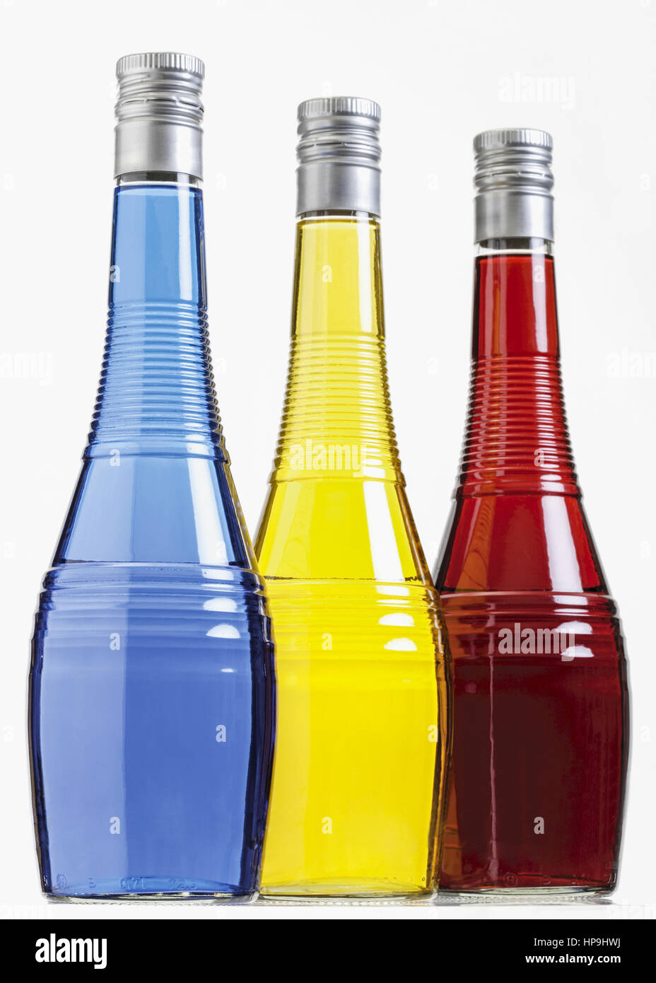 Drei Flaschen mit farbigen Likoeren Stock Photo