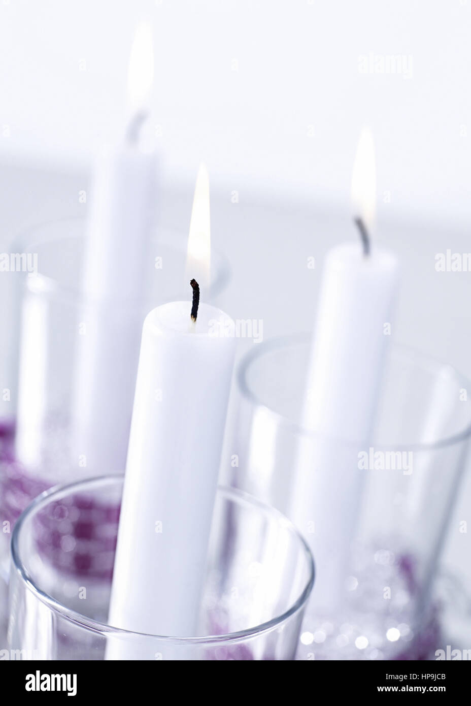 Drei brennende Kerzen in Glaesern Stock Photo