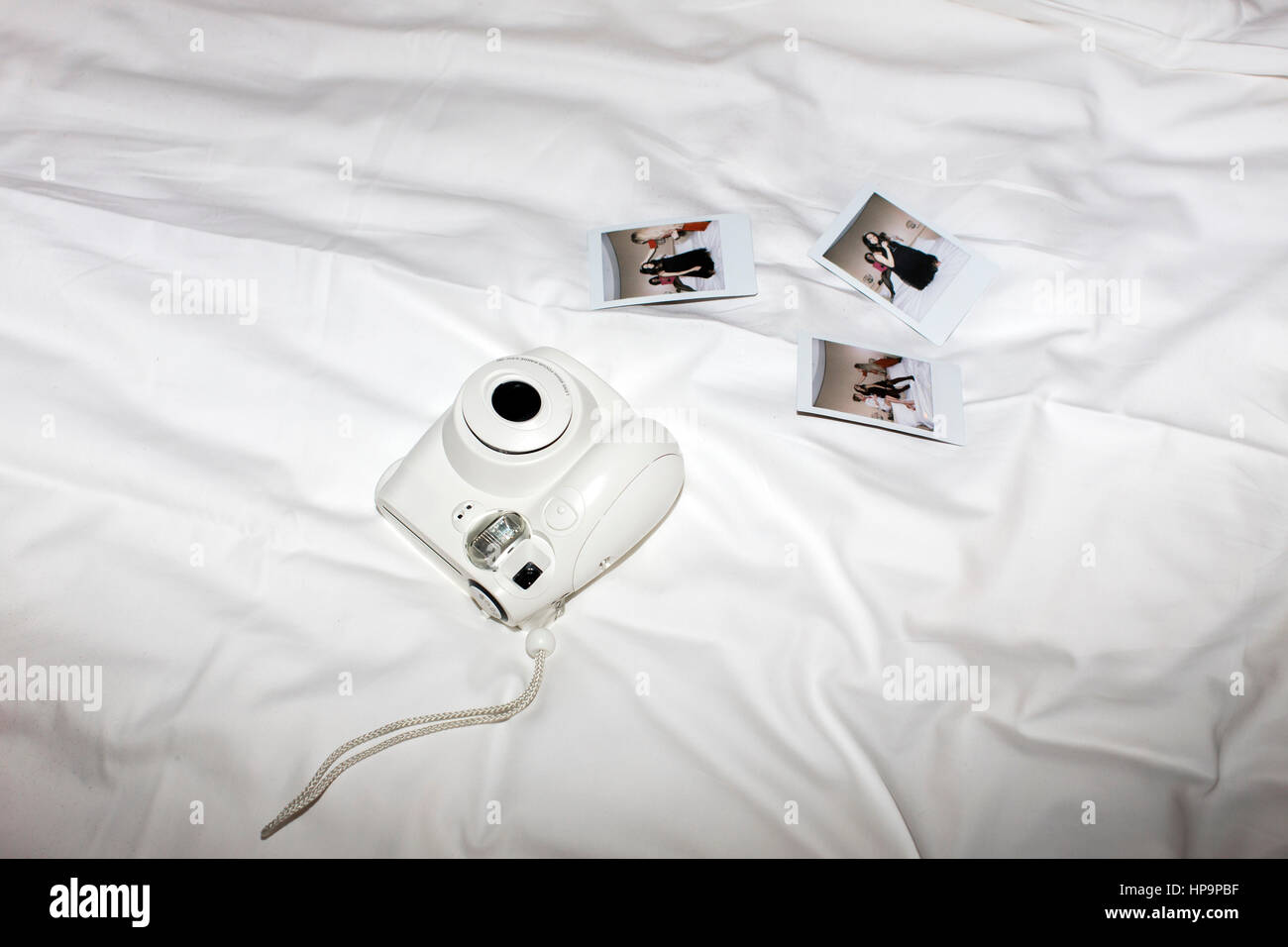 Pop instant camera and several printed photographs Stock Photo