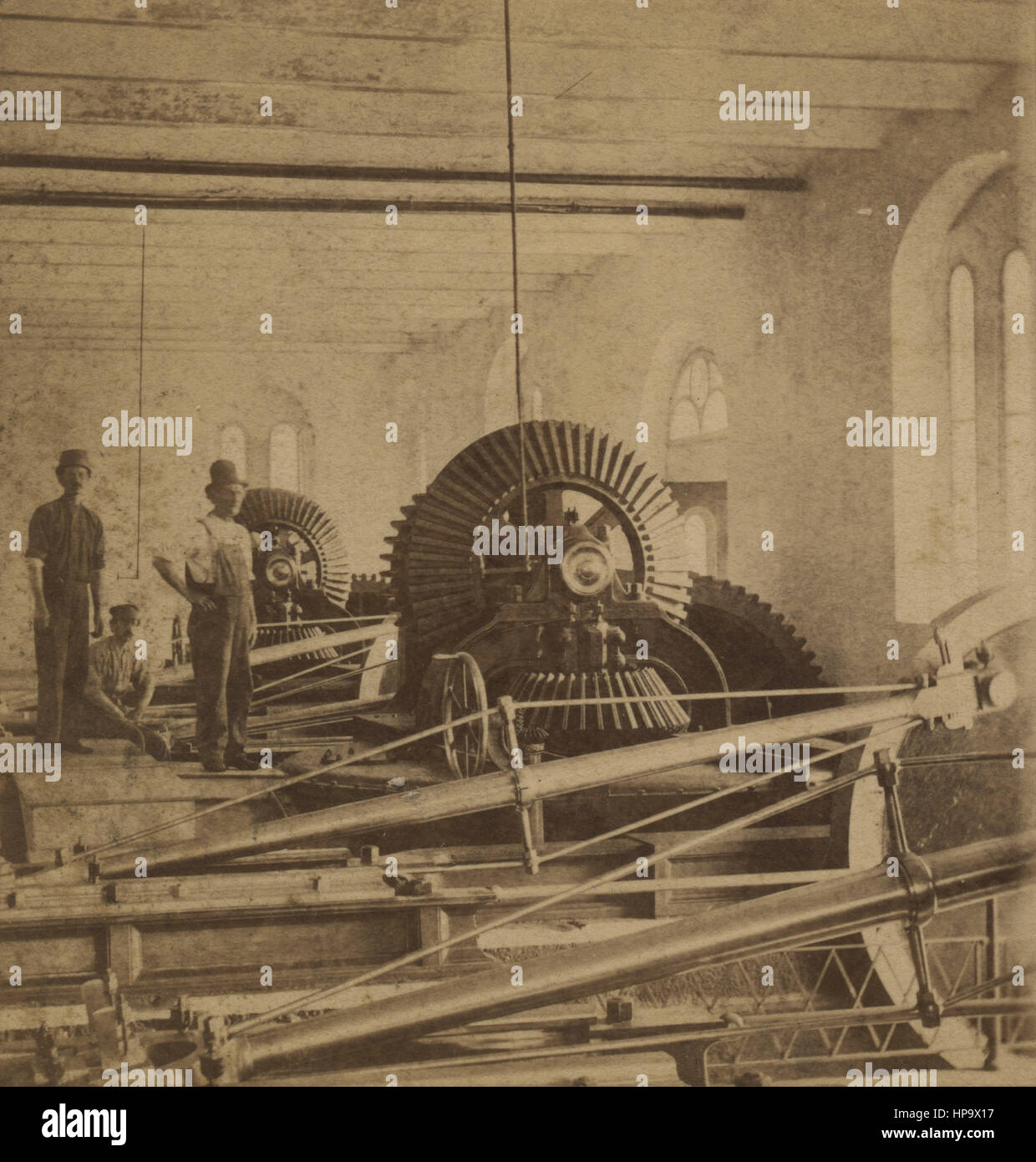 1870s antique industrial American photo of Fairmount Water Works turbine room with engineers and giant gears, cogs, cogwheels. Philadelphia, Pennsylvania. Source: stereoview, stereoscopic card, made by New Jersey Stereoscopic View Co, United States. Stock Photo