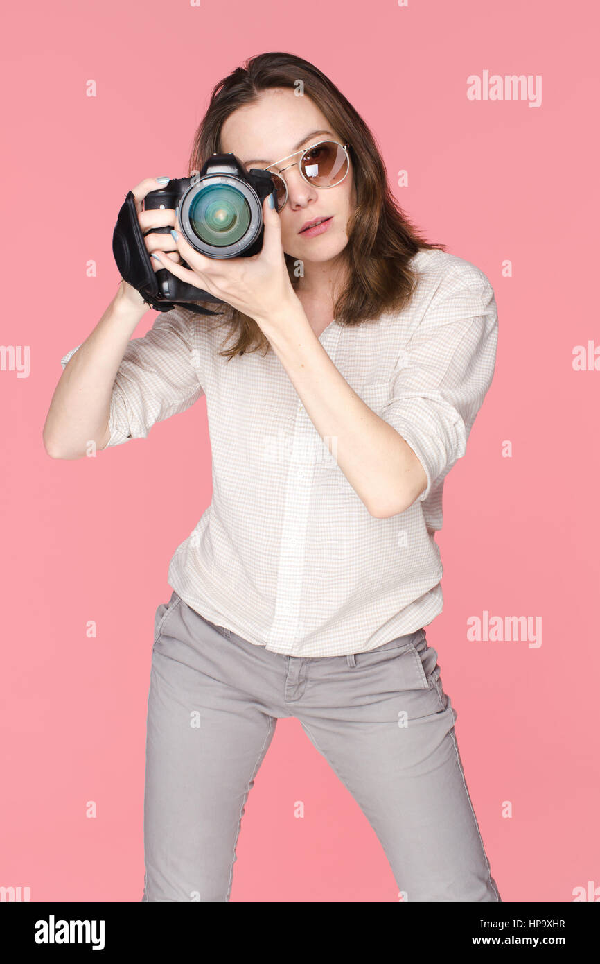 Girl with camera making photos watching to camera Stock Photo Alamy