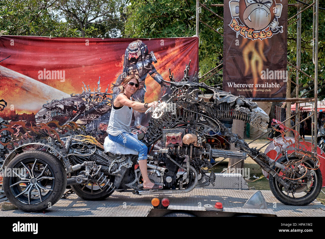 Woman posing for photographs astride an unusual and highly modified tricycle  motorbike at a Thailand biker festival Stock Photo - Alamy