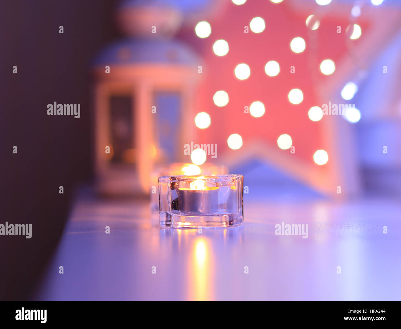 Candles in the evening on blured background. Perfect celebration backdrop. Blured lights on background. Stock Photo